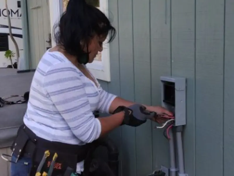 Licensed electrician wiring an exterior subpanel in Lisbon